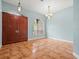 Inviting entryway showcases tile flooring, a chandelier, and beautiful double doors at 2409 Heather Manor Ln, Lutz, FL 33549