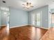 Spacious living room with hardwood flooring and glass doors leading to the outdoors at 2409 Heather Manor Ln, Lutz, FL 33549