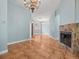 Spacious living room featuring tile floors and a cozy stone fireplace at 2409 Heather Manor Ln, Lutz, FL 33549
