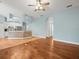 Open-concept living area, with hardwood floors, views into the kitchen, and bright, airy ambiance at 2409 Heather Manor Ln, Lutz, FL 33549