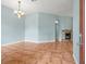 Comfortable living room features tile flooring, a stone fireplace, and a classic chandelier at 2409 Heather Manor Ln, Lutz, FL 33549