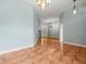 Open living room with tile flooring, light blue walls, and a decorative chandelier at 2409 Heather Manor Ln, Lutz, FL 33549