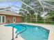 Clear water is pictured in screened in pool at 2409 Heather Manor Ln, Lutz, FL 33549