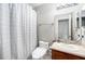 Clean bathroom with a shower-tub combo, a mirror, and a single sink vanity at 2570 Sea Wind Way, Clearwater, FL 33763
