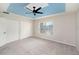 Bright bedroom with ample closet space, a tray ceiling, and a modern ceiling fan at 2570 Sea Wind Way, Clearwater, FL 33763
