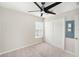 Neutral bedroom featuring a ceiling fan, carpeted floors, and a built-in closet at 2570 Sea Wind Way, Clearwater, FL 33763
