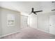 Bright bedroom with carpet floors, a ceiling fan, and a double-door closet at 2570 Sea Wind Way, Clearwater, FL 33763