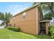 Exterior view of home highlighting the patio and backyard with green lawn at 2570 Sea Wind Way, Clearwater, FL 33763