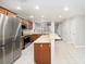 Modern kitchen with stainless steel appliances, tile floors and a large center island at 2570 Sea Wind Way, Clearwater, FL 33763