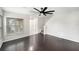 Bright living room with hardwood floors, ceiling fan and staircase at 2570 Sea Wind Way, Clearwater, FL 33763