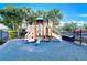 Community playground with colorful equipment and a safety ground cover at 2570 Sea Wind Way, Clearwater, FL 33763