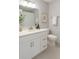 Clean bathroom with a single vanity, modern mirror and lights, and white tile flooring at 2621 Cove Cay Dr # 206, Clearwater, FL 33760