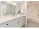 Bright bathroom with a white vanity, modern fixtures, and a separate shower and bathtub at 2621 Cove Cay Dr # 206, Clearwater, FL 33760