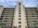 Stunning exterior view of the condo building with multiple stories and beautiful balcony views at 2621 Cove Cay Dr # 206, Clearwater, FL 33760