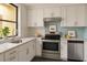 Modern kitchen featuring stainless steel appliances, white cabinets, and beautiful countertops at 2621 Cove Cay Dr # 206, Clearwater, FL 33760
