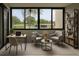 Bright interior living area with desk, seating, and a view of the pool and palm trees outside at 2621 Cove Cay Dr # 206, Clearwater, FL 33760