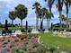 Outdoor seating area overlooking a tranquil lake and golf course, adorned with lush greenery at 2621 Cove Cay Dr # 206, Clearwater, FL 33760