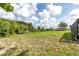 Open backyard area with mature trees, landscaping, and view to separate in-law suite at 271 Eastpoint Ct, Spring Hill, FL 34606