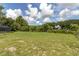 Expansive grassy backyard area with mature trees and landscaping at 271 Eastpoint Ct, Spring Hill, FL 34606