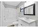 Bathroom featuring a tub, shower and sleek vanity with modern fixtures and a black-framed mirror at 271 Eastpoint Ct, Spring Hill, FL 34606