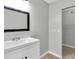 Bathroom featuring a sleek white vanity with a black-framed mirror and neutral paint at 271 Eastpoint Ct, Spring Hill, FL 34606