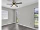 Bedroom featuring a ceiling fan, two windows and gray vinyl floors at 271 Eastpoint Ct, Spring Hill, FL 34606