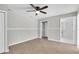 Large bedroom features a wood floor, ceiling fan, wainscoting and two doorways at 271 Eastpoint Ct, Spring Hill, FL 34606