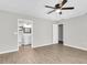 Spacious bedroom showcasing wood-look flooring, neutral colors, and bathroom access at 271 Eastpoint Ct, Spring Hill, FL 34606