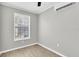 A brightly lit bedroom with a ceiling fan and window at 271 Eastpoint Ct, Spring Hill, FL 34606