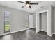 Bedroom featuring a ceiling fan, two windows and grey vinyl floors at 271 Eastpoint Ct, Spring Hill, FL 34606
