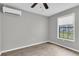 A bright bedroom with laminate floors, window, and ceiling fan at 271 Eastpoint Ct, Spring Hill, FL 34606