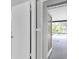 A white door leading out to a screened-in pool area at 271 Eastpoint Ct, Spring Hill, FL 34606
