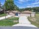 A single-story house shows a long driveway and neutral colors at 271 Eastpoint Ct, Spring Hill, FL 34606