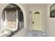 The front of the house is inviting with an arched porch and a bright yellow door at 271 Eastpoint Ct, Spring Hill, FL 34606