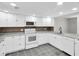 Bright kitchen features white cabinets, appliances, gray countertops and stylish tile flooring at 271 Eastpoint Ct, Spring Hill, FL 34606