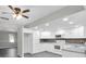 Spacious kitchen features white cabinets, appliances, gray countertops and stylish tile flooring at 271 Eastpoint Ct, Spring Hill, FL 34606