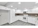 Modern kitchen features bright white cabinets, updated appliances and gray tiled floor at 271 Eastpoint Ct, Spring Hill, FL 34606