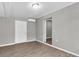 Living room featuring gray walls, wood flooring, and a doorway leading to another room at 271 Eastpoint Ct, Spring Hill, FL 34606