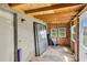 Unfinished patio with plywood siding and exposed beams, with windows overlooking the backyard at 271 Eastpoint Ct, Spring Hill, FL 34606