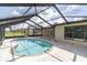 Screened-in pool area features a kidney shaped pool and outdoor entertaining area at 271 Eastpoint Ct, Spring Hill, FL 34606