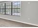 An empty room featuring light wood-look flooring, fresh paint and a window providing natural light at 271 Eastpoint Ct, Spring Hill, FL 34606