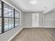 A modern room with wood-look flooring and views of the pool from the large window at 271 Eastpoint Ct, Spring Hill, FL 34606