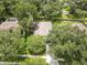 An aerial view of a home with a large backyard, surrounded by lush greenery at 2910 Red Coat Cir, Brandon, FL 33511