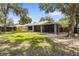 Large backyard featuring a screened lanai attached to the house, perfect for outdoor relaxation and entertainment at 2910 Red Coat Cir, Brandon, FL 33511