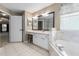 Large bathroom with double vanity, soaking tub, and tile flooring at 2910 Red Coat Cir, Brandon, FL 33511