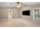 Neutral bedroom featuring a ceiling fan, neutral carpeting, and a doorway leading to other areas of the home at 2910 Red Coat Cir, Brandon, FL 33511