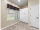 Bedroom with closet, window, neutral paint, and wood-look flooring at 2910 Red Coat Cir, Brandon, FL 33511