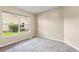 Bright bedroom with neutral walls, carpet flooring, and a large window overlooking the yard at 2910 Red Coat Cir, Brandon, FL 33511