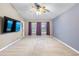Spacious bedroom featuring a ceiling fan, large windows with purple curtains, and a door to the outside at 2910 Red Coat Cir, Brandon, FL 33511