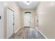 Welcoming entryway with wood-look flooring, a front door with sidelight, and neutral paint at 2910 Red Coat Cir, Brandon, FL 33511